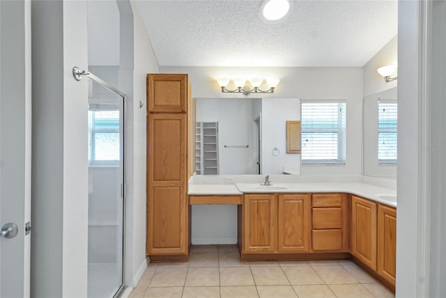 bathroom with walk in shower, plenty of natural light, a textured ceiling, and tile flooring