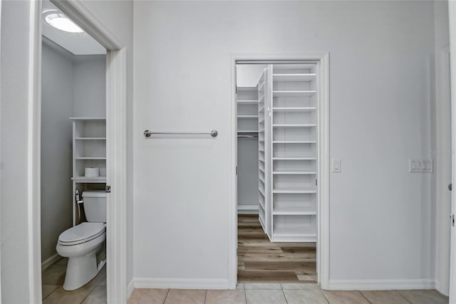 bathroom with toilet and tile flooring