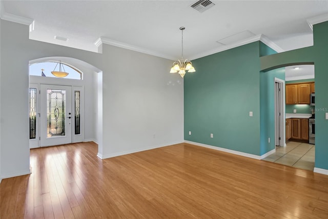 entryway featuring a chandelier, crown molding, and light hardwood / wood-style flooring