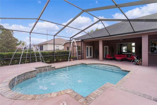 view of pool featuring pool water feature, ceiling fan, a lanai, and a patio