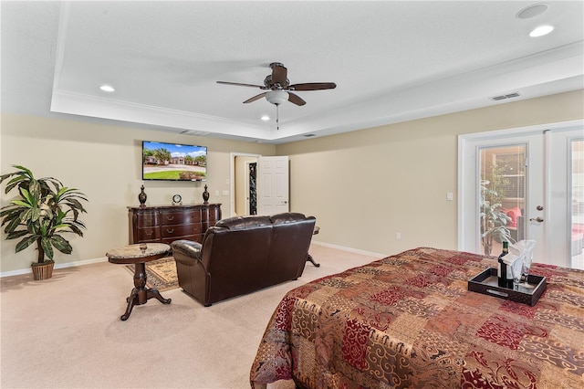 carpeted bedroom with a raised ceiling, ceiling fan, and access to outside