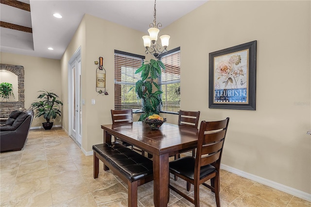 dining space featuring a notable chandelier and light tile floors