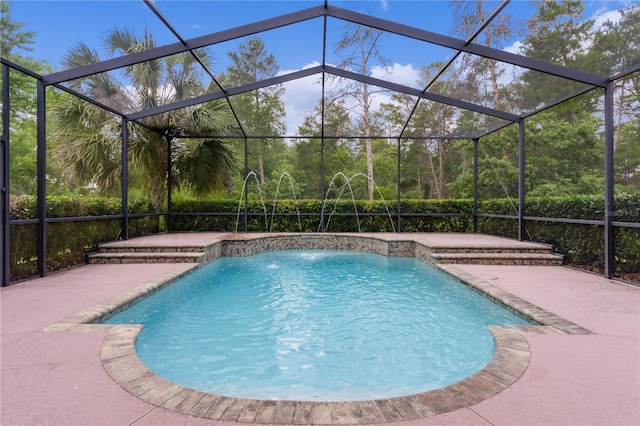 view of swimming pool featuring a patio area, pool water feature, and glass enclosure