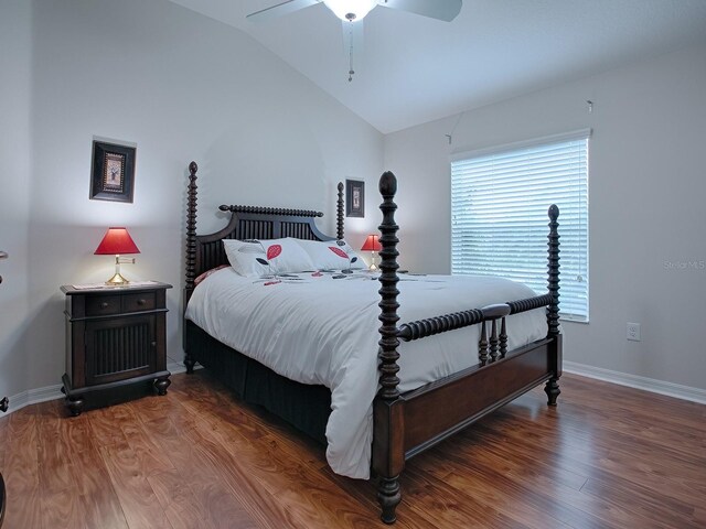 bedroom with vaulted ceiling, ceiling fan, dark wood-style floors, and baseboards