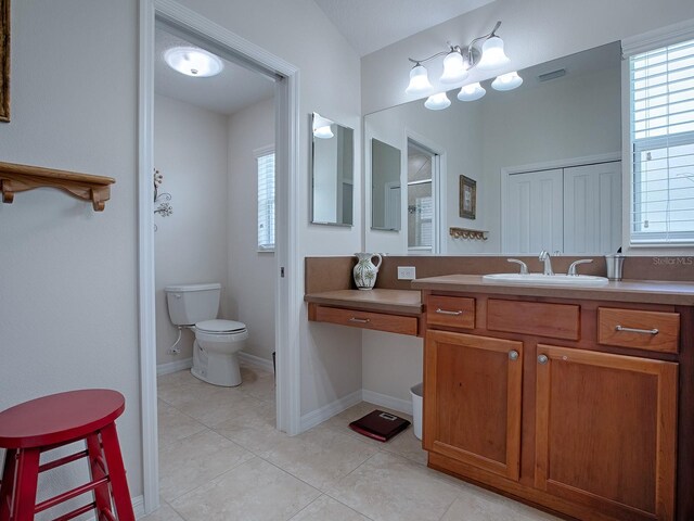 bathroom featuring toilet, plenty of natural light, visible vents, and tile patterned flooring