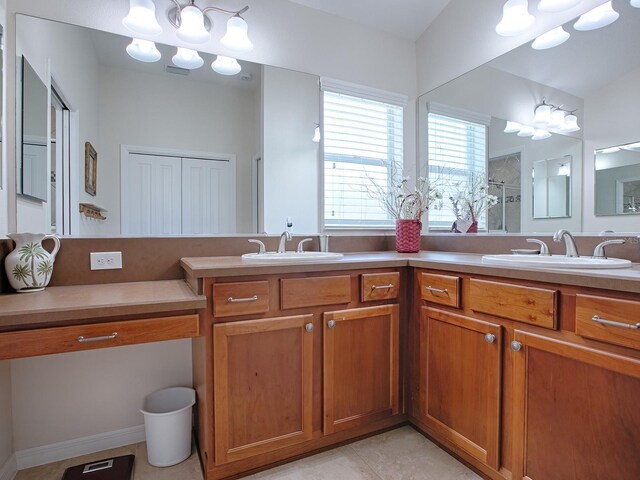 bathroom featuring double vanity, a sink, visible vents, and a shower stall