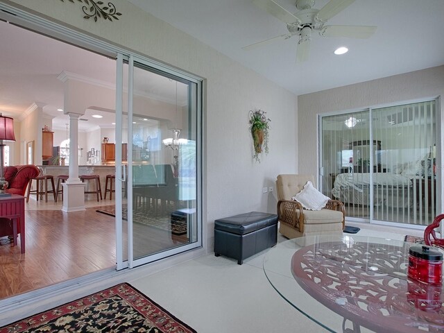 interior space featuring decorative columns and ceiling fan