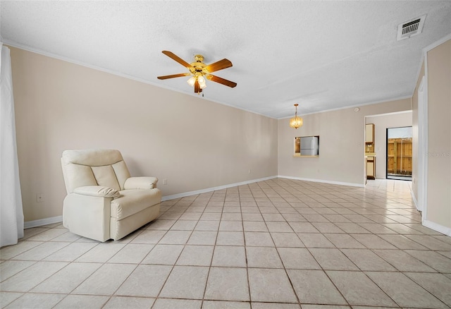 unfurnished room featuring ceiling fan with notable chandelier, a textured ceiling, light tile patterned floors, and crown molding