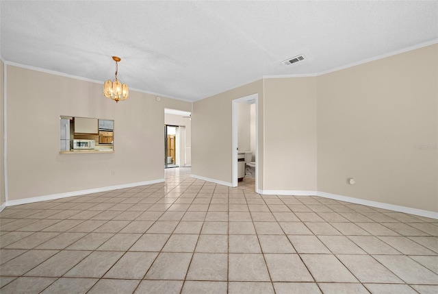 spare room featuring a textured ceiling, an inviting chandelier, ornamental molding, and light tile patterned floors