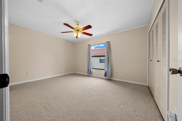 unfurnished bedroom with carpet flooring, a textured ceiling, and ceiling fan