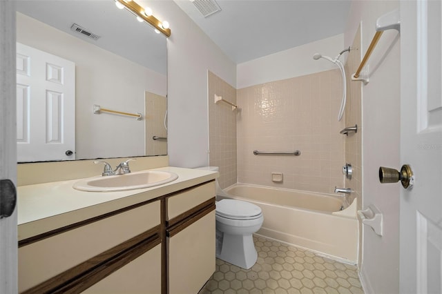 full bathroom featuring toilet, vanity, and tiled shower / bath