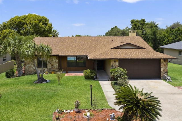 single story home featuring a garage and a front lawn