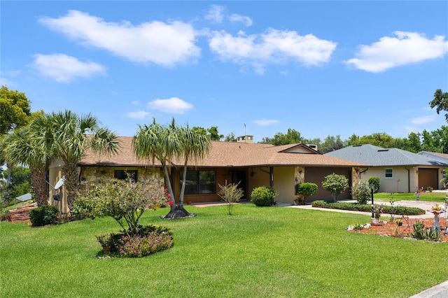 single story home featuring a front lawn