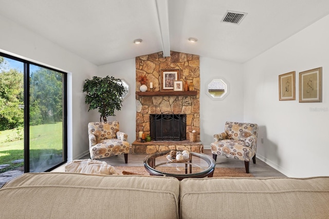 living room featuring a fireplace, lofted ceiling with beams, and hardwood / wood-style flooring