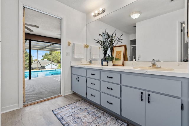 bathroom featuring ceiling fan, vanity, a textured ceiling, and hardwood / wood-style flooring