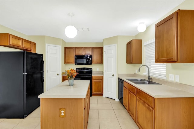 kitchen featuring hanging light fixtures, light tile patterned flooring, black appliances, sink, and a center island