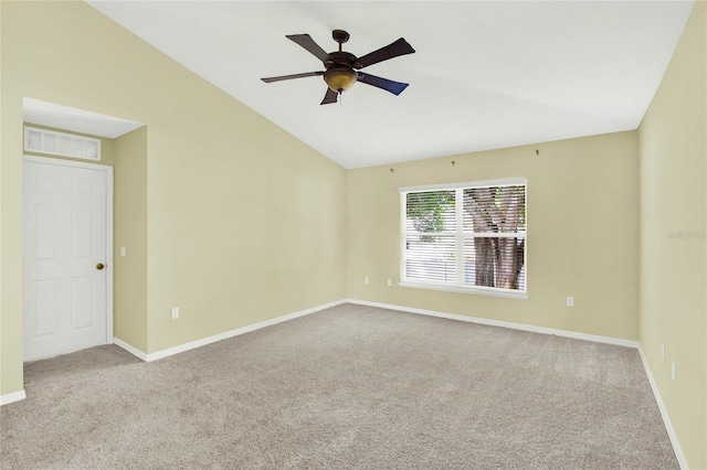 empty room with lofted ceiling, light colored carpet, and ceiling fan