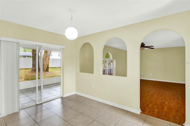 spare room with light wood-type flooring and ceiling fan