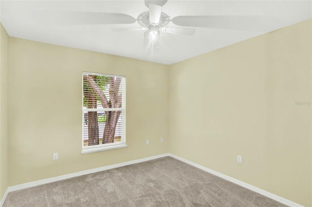 empty room featuring light carpet and ceiling fan