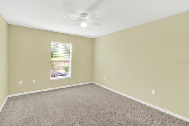 spare room featuring carpet flooring and ceiling fan