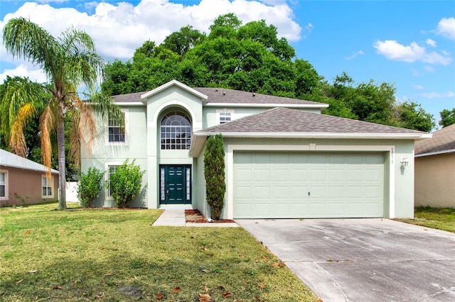 view of front of home with a front yard and a garage