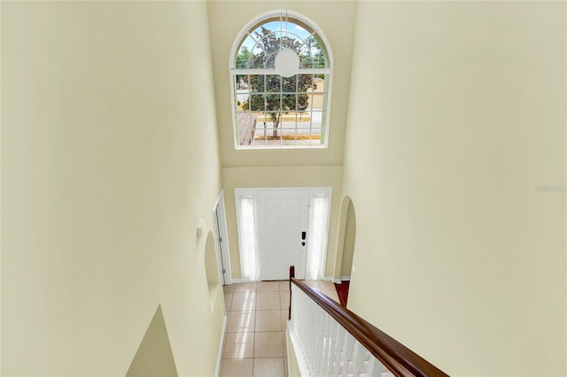 entrance foyer with a high ceiling and light tile patterned floors