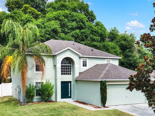 view of front of property featuring a front lawn and a garage