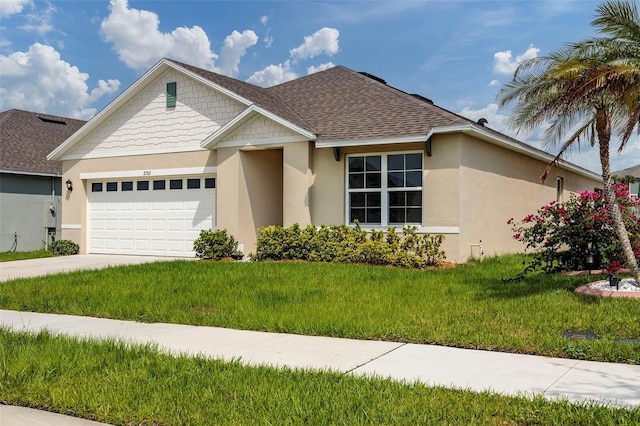 view of front of property with a garage and a front lawn