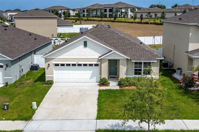 ranch-style home with central AC unit, a garage, and a front yard