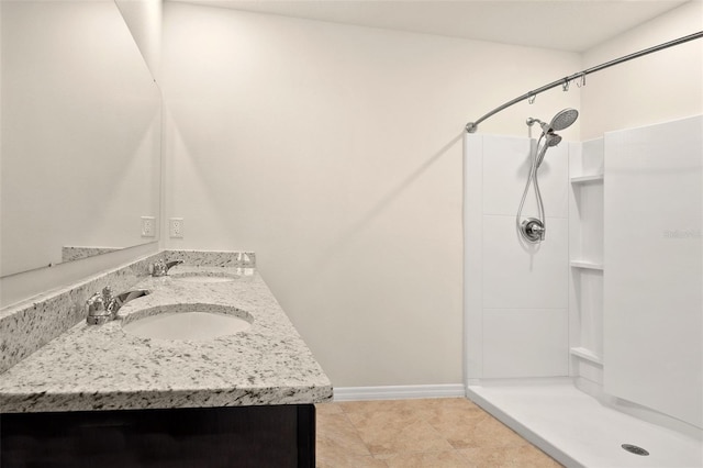 bathroom featuring a shower, tile patterned flooring, and vanity