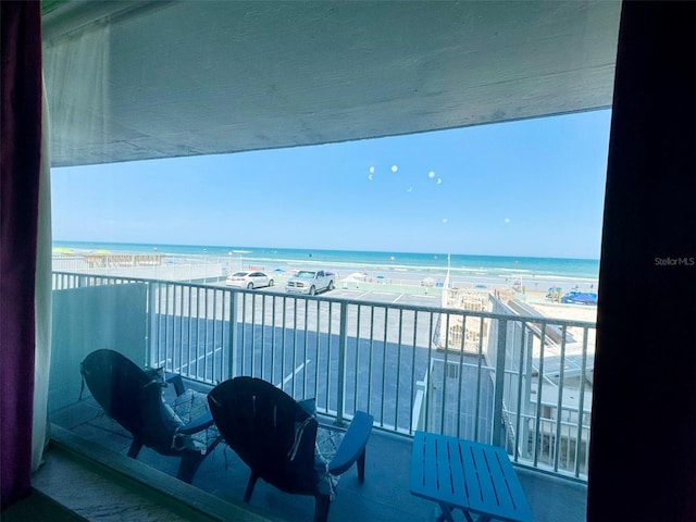 balcony with a beach view and a water view