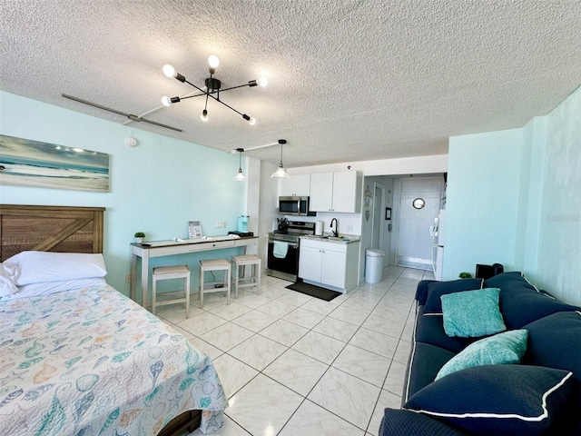 tiled bedroom with sink, a textured ceiling, white fridge, and ensuite bathroom