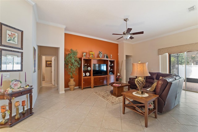 tiled living room featuring ceiling fan and crown molding