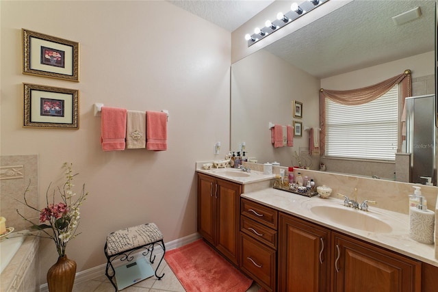 bathroom featuring a textured ceiling, vanity, an enclosed shower, and tile patterned floors