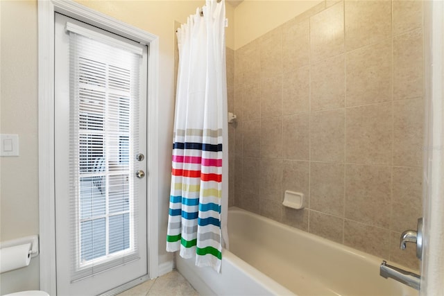 bathroom featuring shower / tub combo, tile patterned flooring, and a wealth of natural light