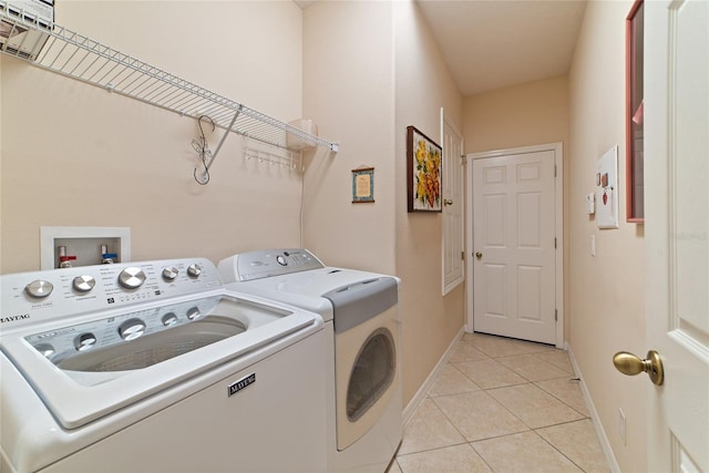 washroom featuring light tile patterned floors and washing machine and dryer