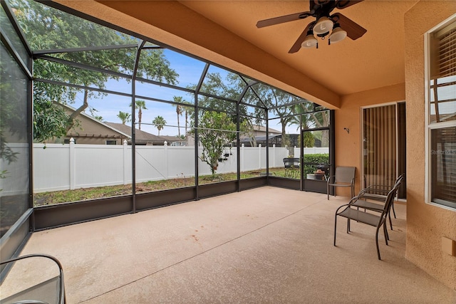 unfurnished sunroom with ceiling fan