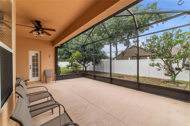 exterior space with ceiling fan and glass enclosure