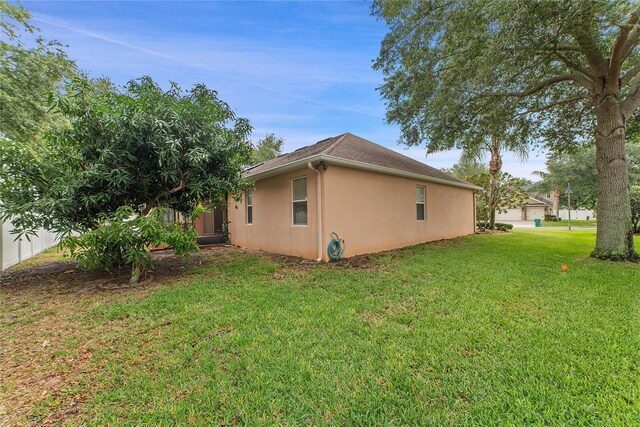 view of side of property with a lawn