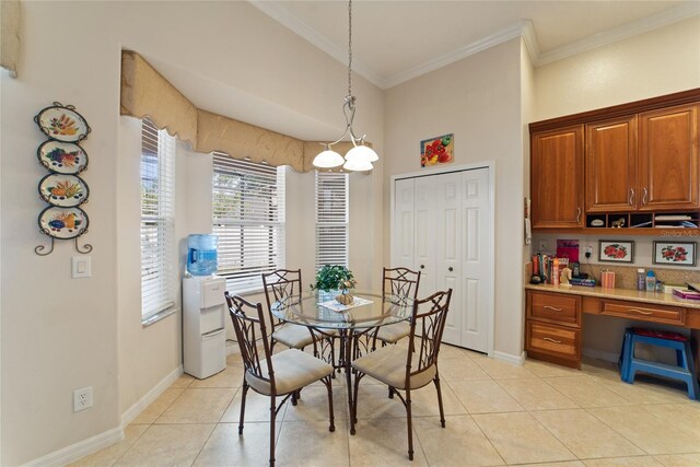 dining space with crown molding, light tile patterned flooring, and a chandelier