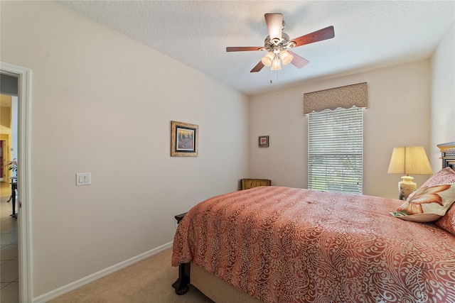 carpeted bedroom with a textured ceiling and ceiling fan