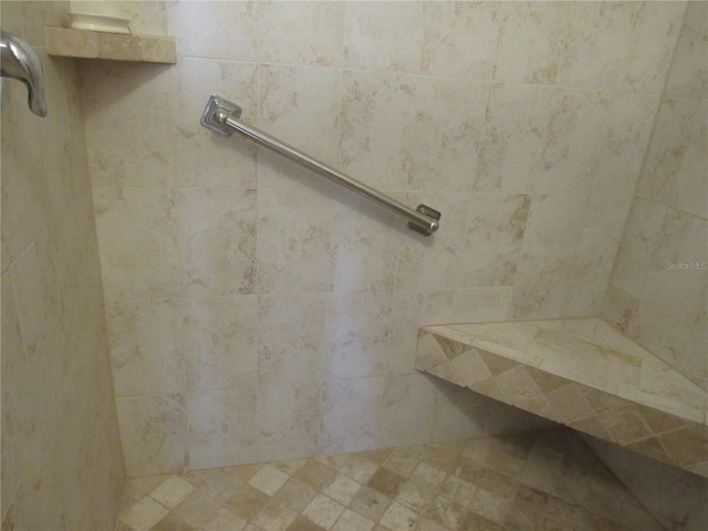 bathroom with a tile shower