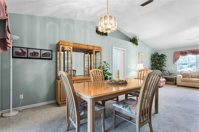 carpeted dining room with vaulted ceiling, a textured ceiling, and ceiling fan with notable chandelier