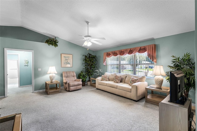 carpeted living room with a textured ceiling, lofted ceiling, and ceiling fan