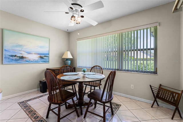 dining room with ceiling fan and light tile floors