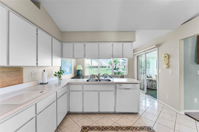 kitchen featuring white dishwasher, sink, white cabinets, and light tile flooring