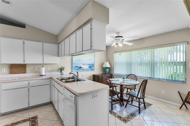 kitchen with dishwasher, ceiling fan, white cabinets, sink, and light tile floors