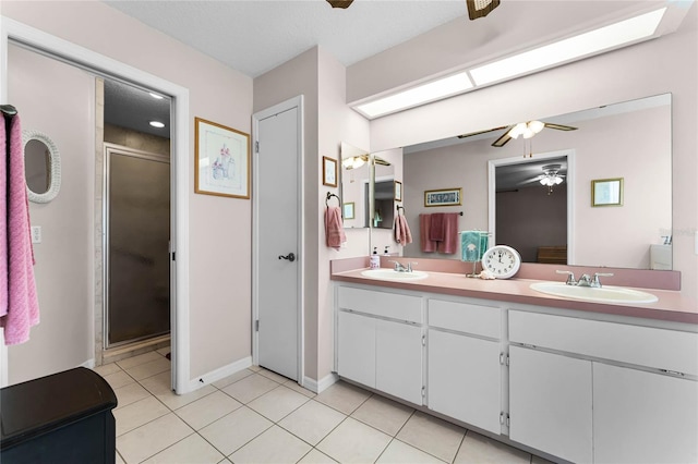 bathroom with tile floors, walk in shower, ceiling fan, and double sink vanity