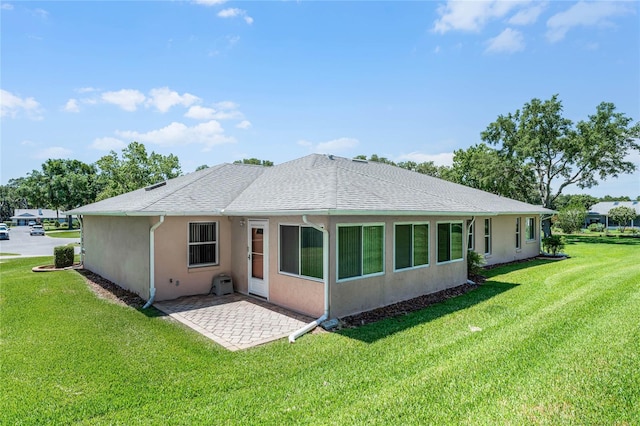 rear view of property with a patio and a yard