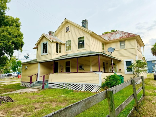 country-style home with a front yard and a porch